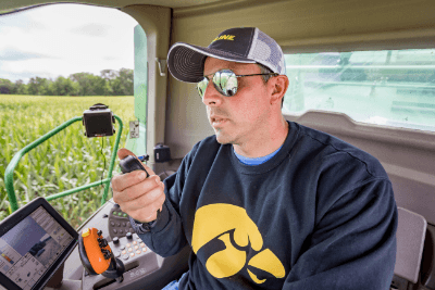 man uses MicroMobile mic in cab of tractor