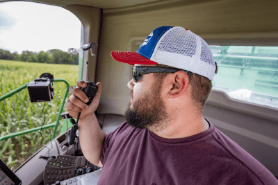 man uses MicroMobile mic in cab of tractor