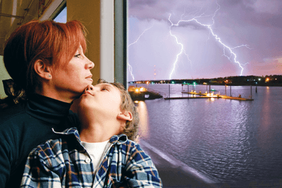 mom and kid looking at storm outside window