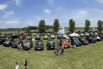 off-road vehicles lined up in grass