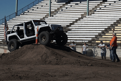 off-road vehicle goes over dirt hill