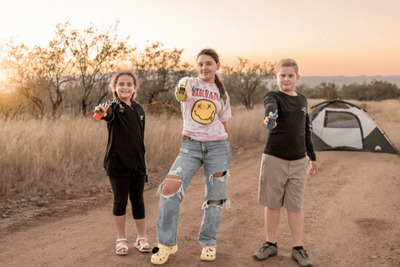 kids hold multi-color walkie talkies