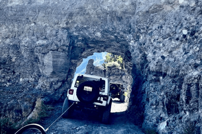 Jeep goes through pass with recovery straps attached