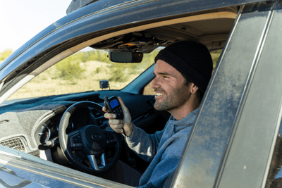 man in vehicle holding Midland MicroMobile microphone