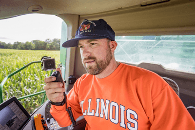 farmer in cab of tractor with mobile GMRS radio mic