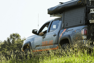overlanding vehicle on trail of grass