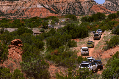off-road vehicles travel in convoy on trail in Palo Duro Canyon
