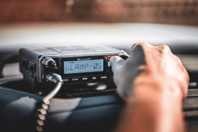 man turns knob on MicroMobile GMRS two-way radio