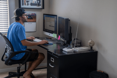 man sits at desk with NOAA Weather Radio