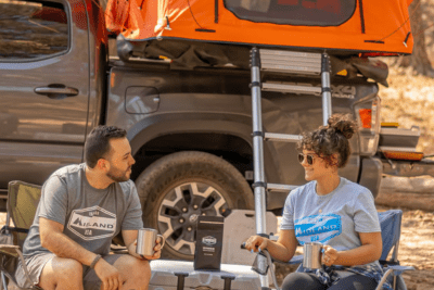 campers sit at campfire