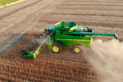aerial shot of combine harvest corn in field