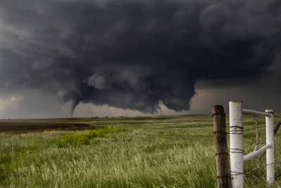 view of farm with tornado and dark clouds rolling in