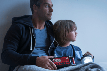 man and child hold emergency radio