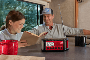 father and daughter in RV with ER310 emergency radio