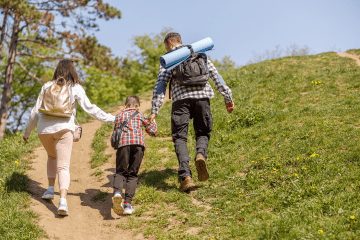 family hikes up hill
