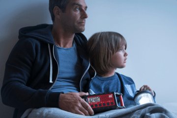man and child hold emergency radio