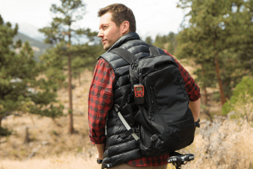 man with backup holding walkie talkie