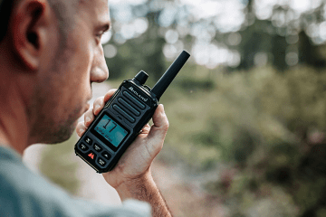 man holds walkie talkie