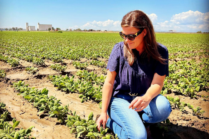 woman stands in farm field
