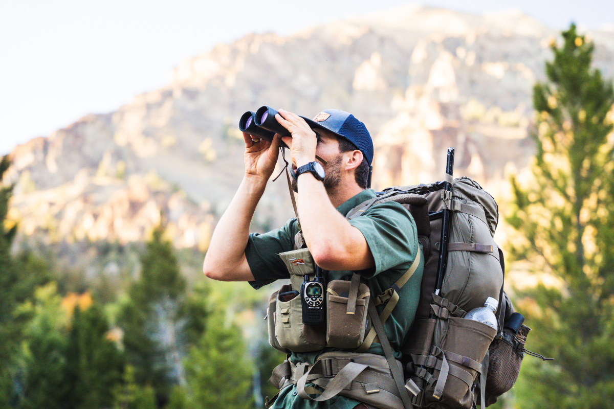 man looks in binoculars