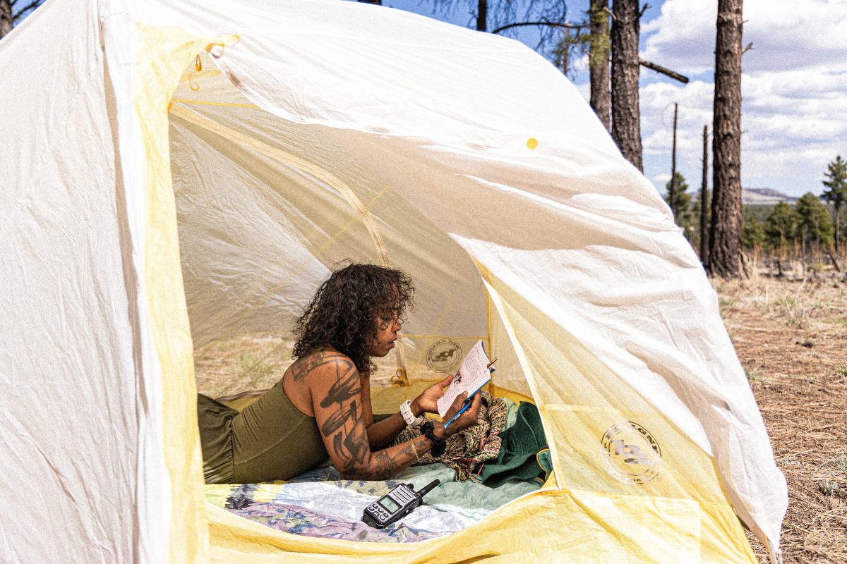 girl reading in tent