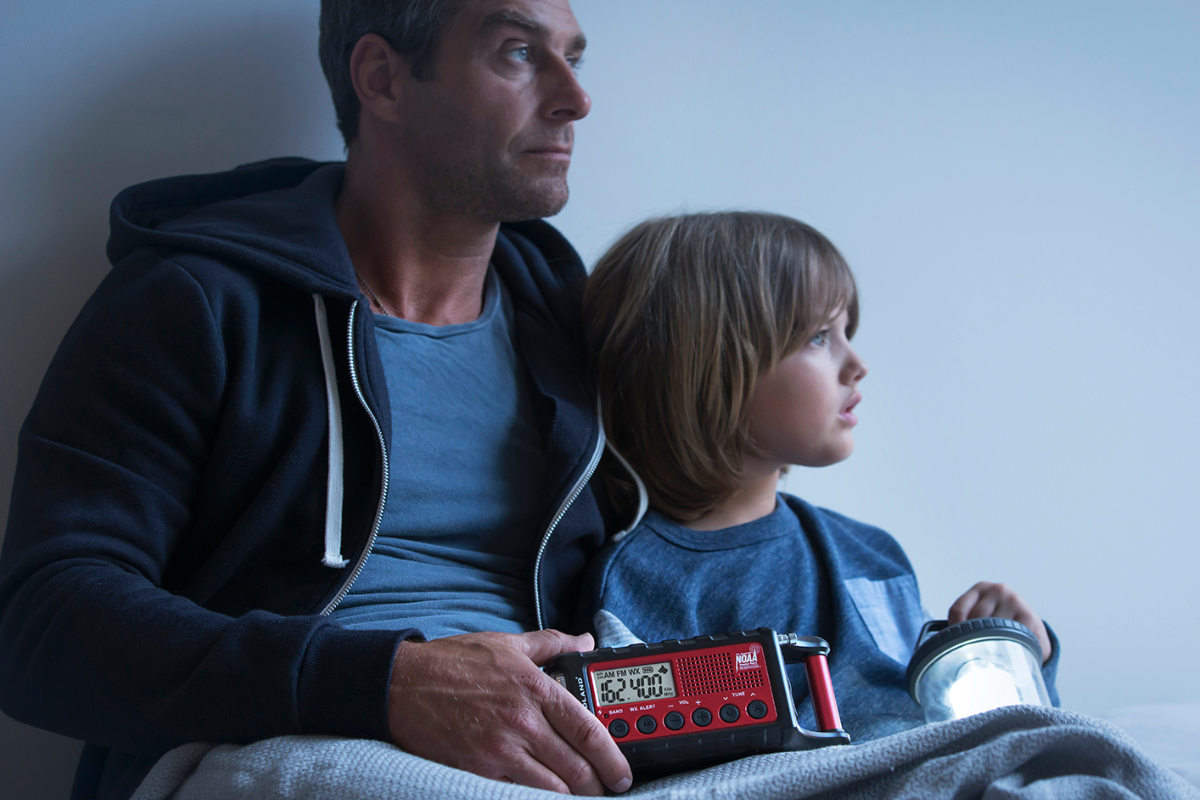 father and son hold emergency radio