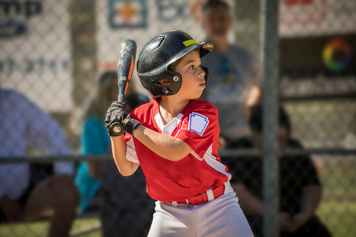 child at plate during baseball game