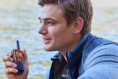 man uses orange walkie talkie