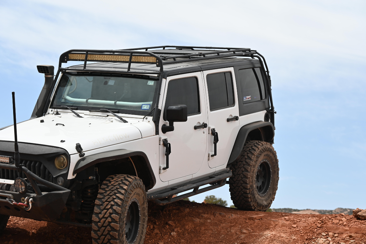Jeep with antenna goes over hill