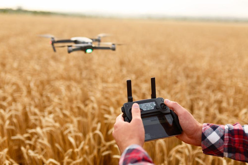 farmer holdes drone in field