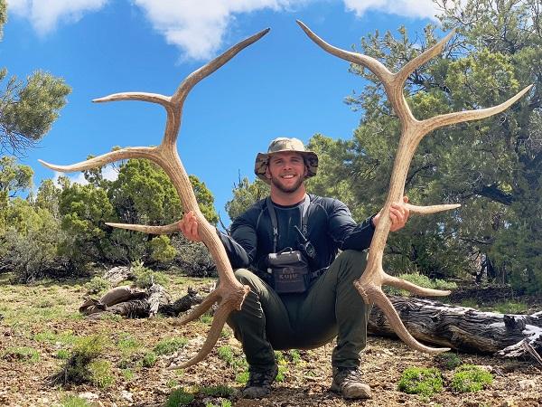 man stands with hunting antlers