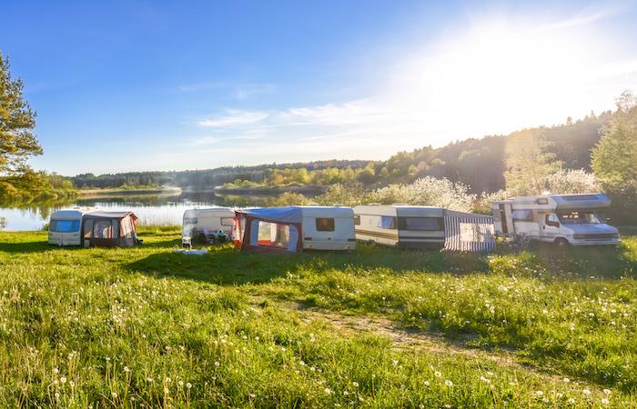 RVs in grass near water