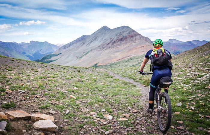 mountain biker heading towards mountain