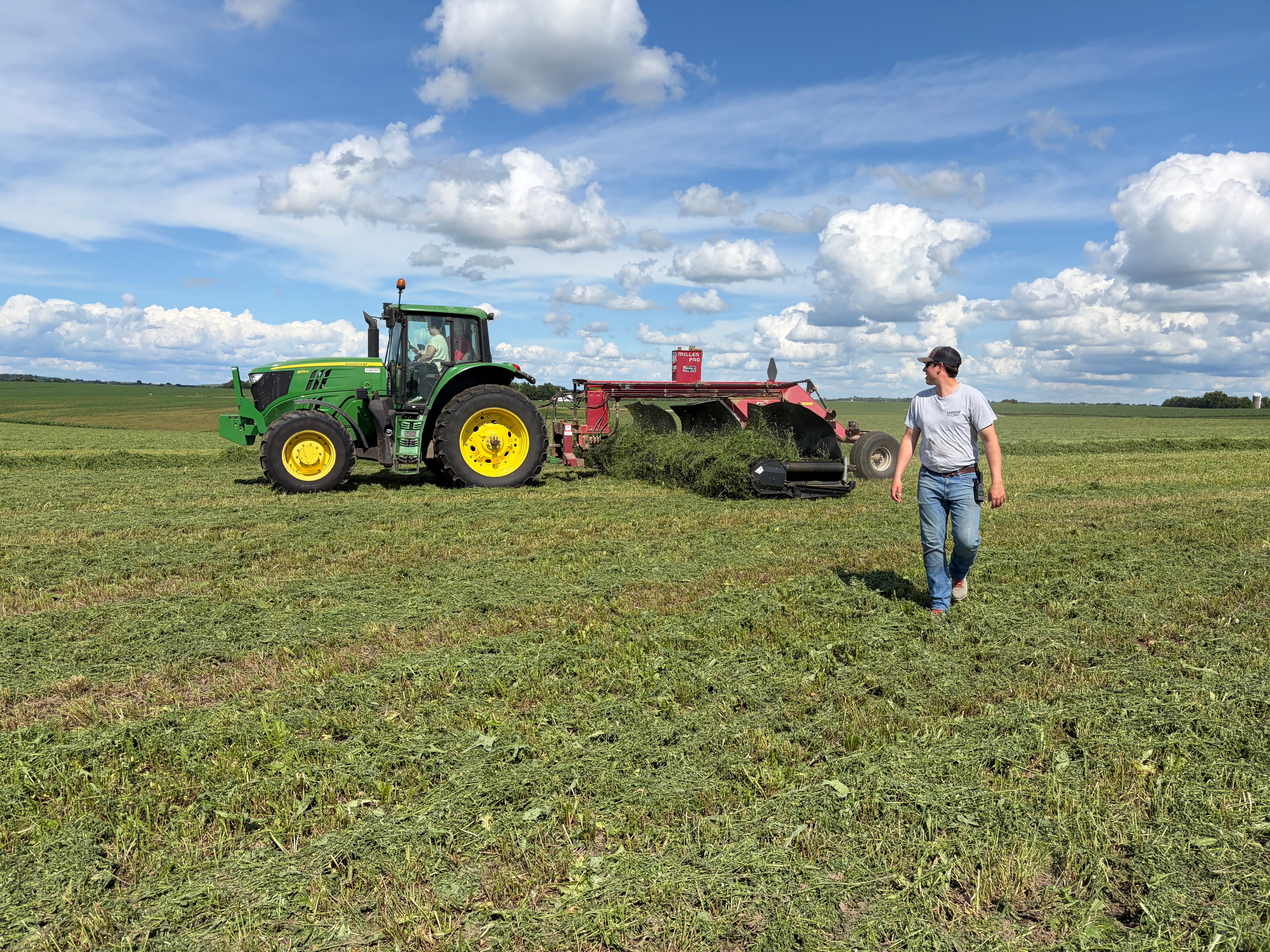 farmer stands by tractor